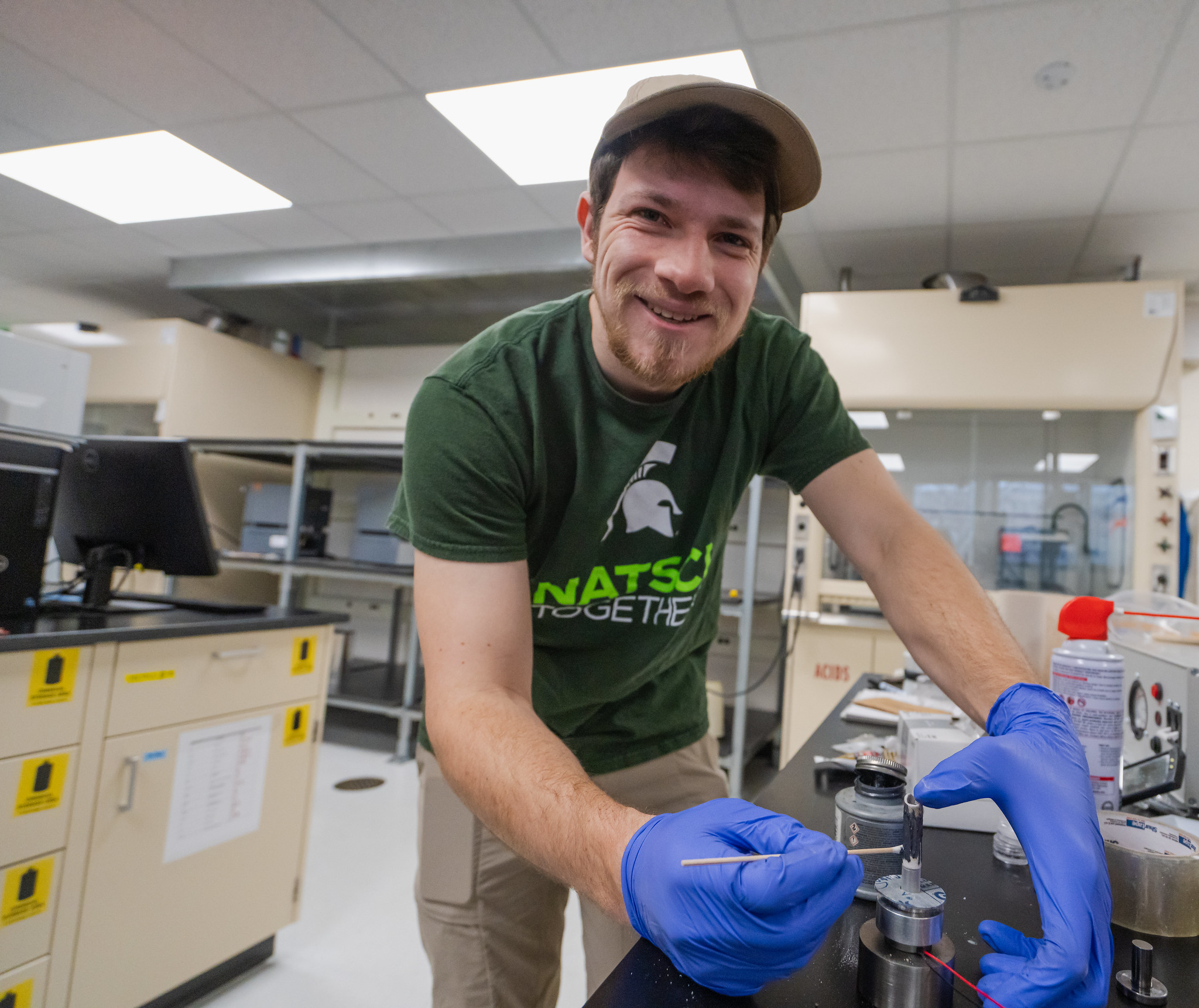 student wearing msu shirt in a lab setting